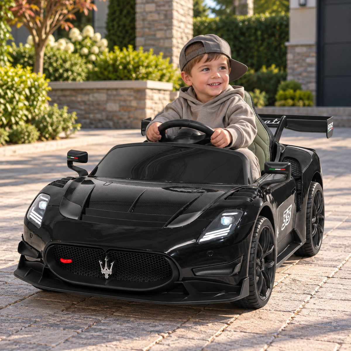 Black Maserati GT2 24V Kids Ride-On Car, Boy Driving on a Villa Driveway