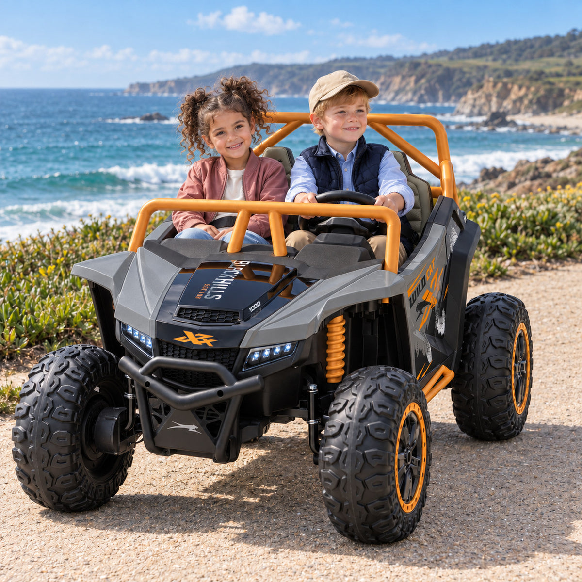 Gray Arctic Cat XL 24V 4WD Two Seat Kids UTV Side by Side, Lifestyle Photo of Two Kids Riding by the Ocean