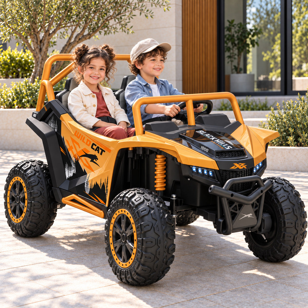 Honey Gold Arctic Cat XL 24V 4WD Kids Ride-On UTV, Two Seater Lifestyle Photo of Two Kids Driving on a Driveway