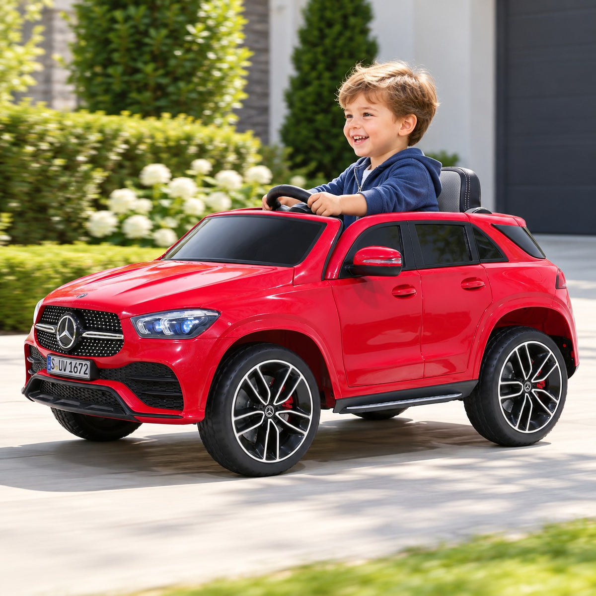 Red Mercedes Kids Electric Car GLE450 12V Lifestyle, Smiling Toddler at the Wheel, Front Left View