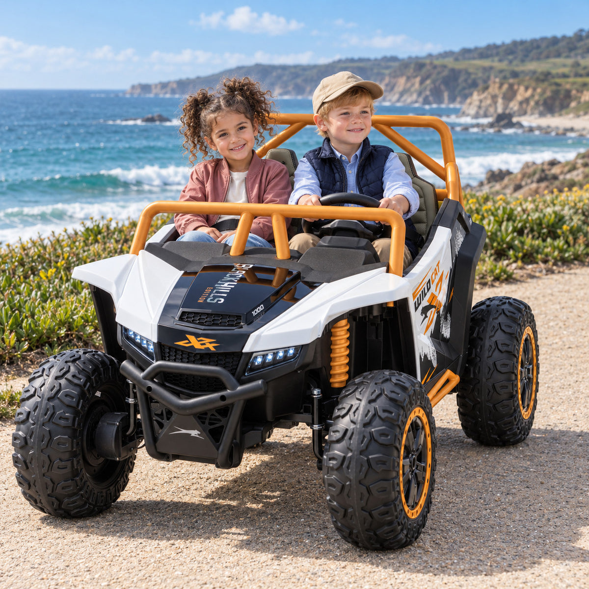 White Arctic Cat XL 24V 4WD Two Seat Kids UTV Side by Side, Lifestyle Photo of Two Kids Riding by the Ocean