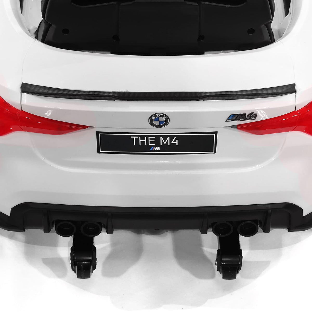 Rear of the White BMW M4 12V Kids Car with Folding Caster Wheels Under the Bumper