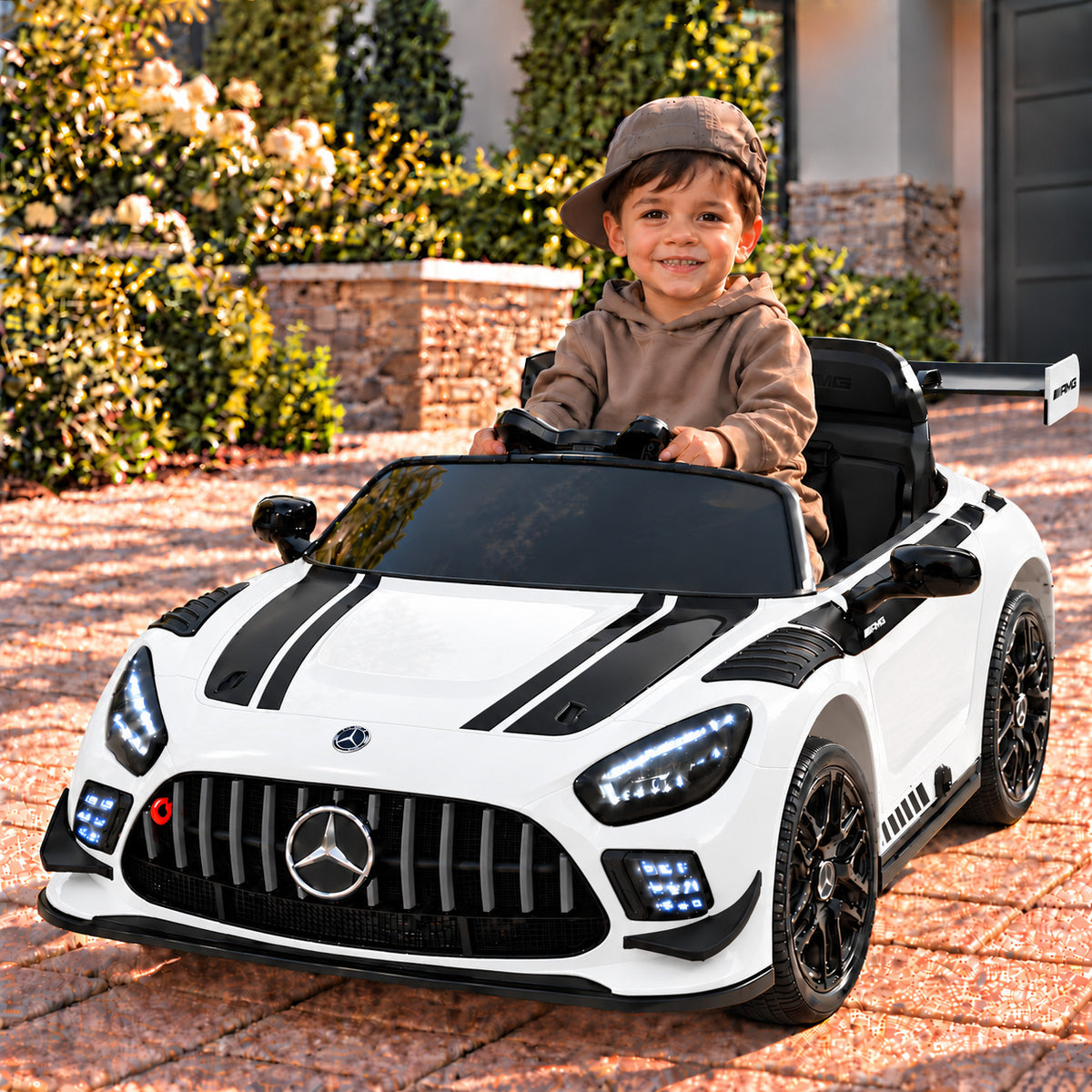White Mercedes AMG GT3 EVO 12V Kids Ride-On Car with Parental Remote, Boy Driving on a Driveway