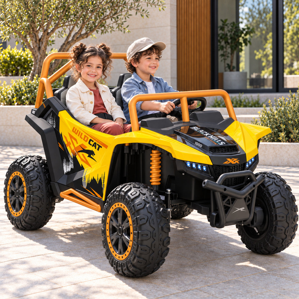 Yellow Arctic Cat XL 24V 4WD Kids Ride-On UTV, Two Seater Lifestyle Photo of Two Kids Driving on a Driveway