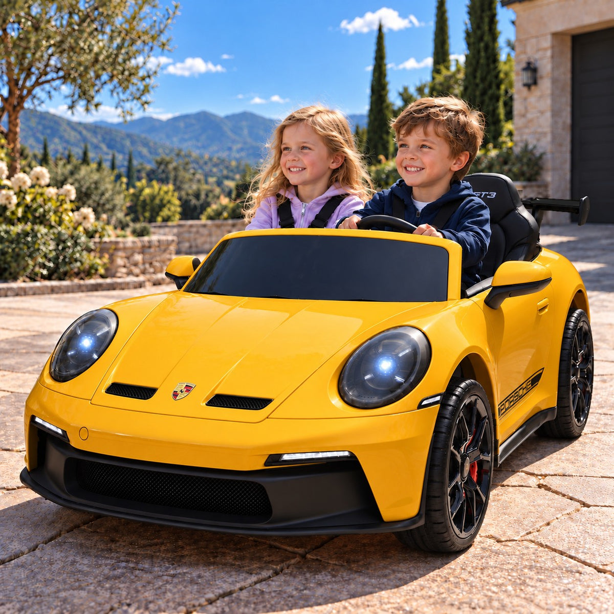 Yellow Porsche 911 GT3 24V Kids 2 Seater Ride-On Car, Boy and Girl Driving on a Villa Driveway