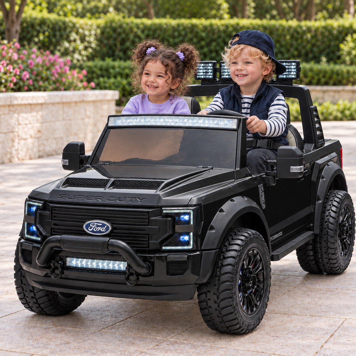 Black Ford F450 Custom Edition 24V Kids Ride-On Truck, Two Seat Lifestyle Photo of Two Toddlers Driving