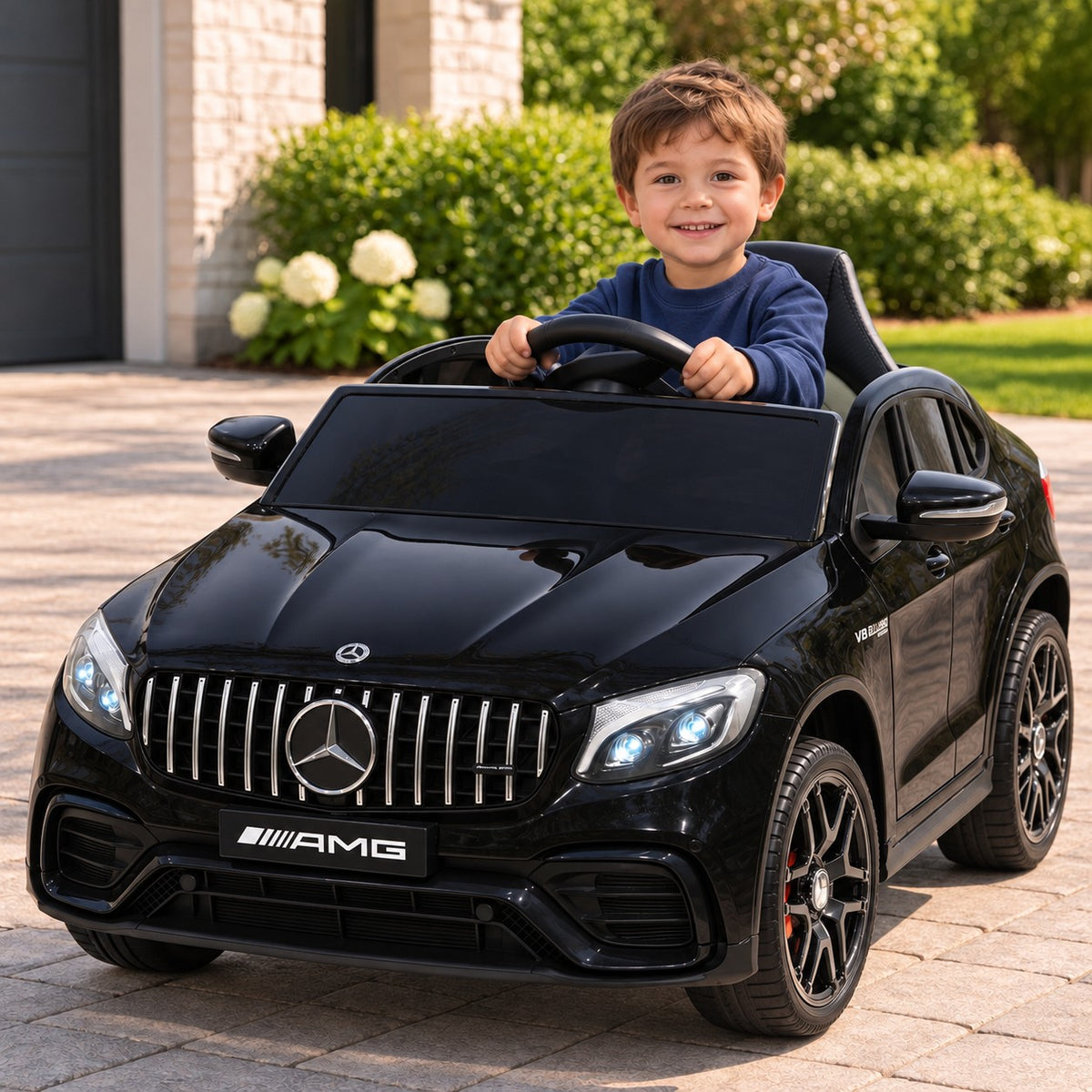 Black Mercedes AMG GLC 63S 12V 4WD Kids Ride-On Car, Boy Driving on a Driveway