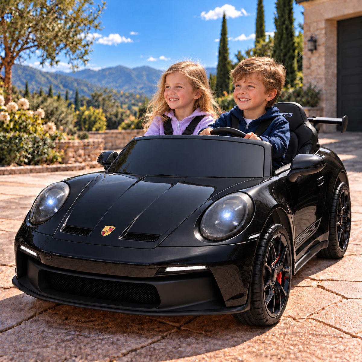 Black Porsche 911 GT3 24V Kids 2 Seater Ride-On Car, Boy and Girl Driving on a Villa Driveway