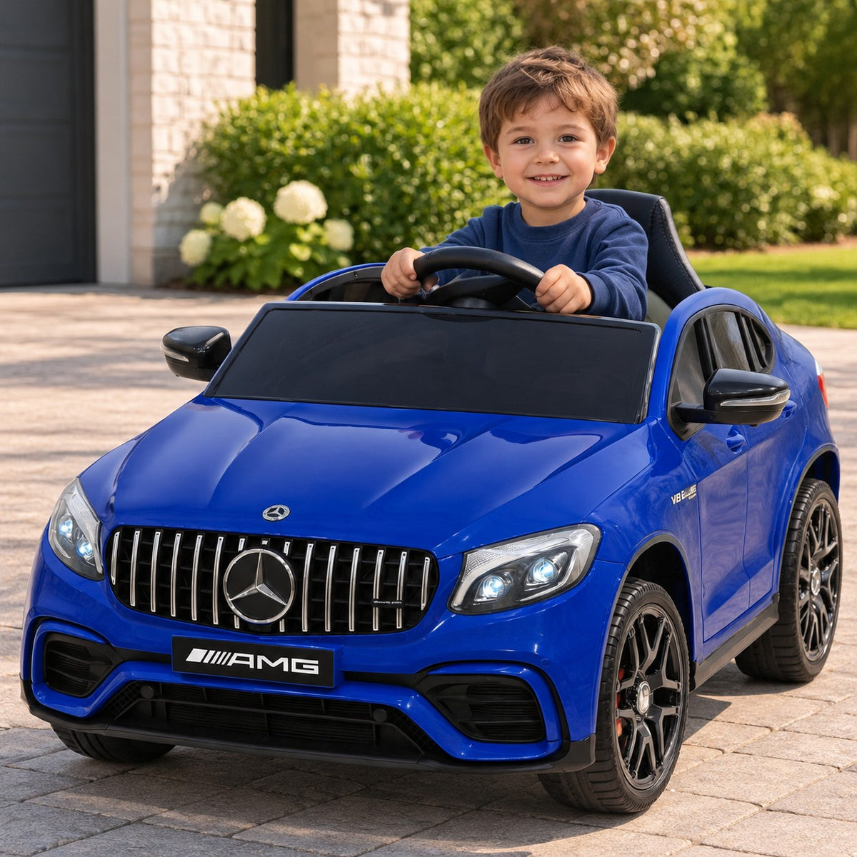Blue Mercedes AMG GLC 63S 12V 4WD Kids Ride-On Car, Boy Driving on a Driveway