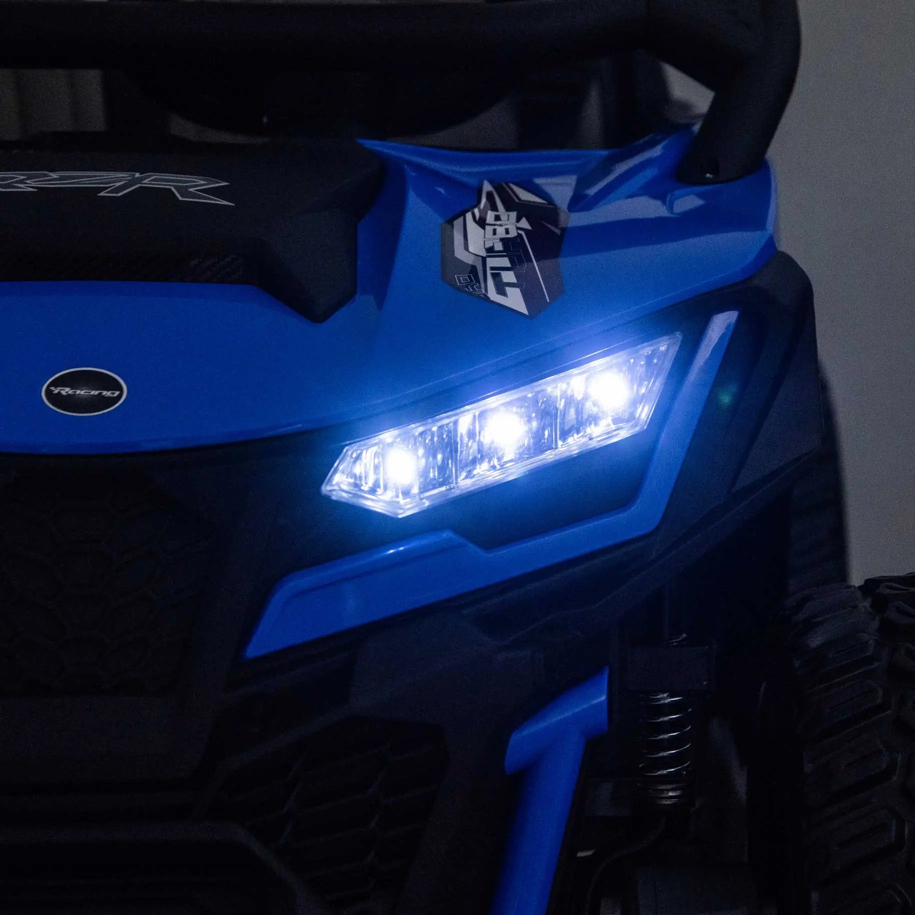 Blue Trail Runner 24V 4WD kids electric ride-on UTV with LED headlights illuminated, front close-up view-2