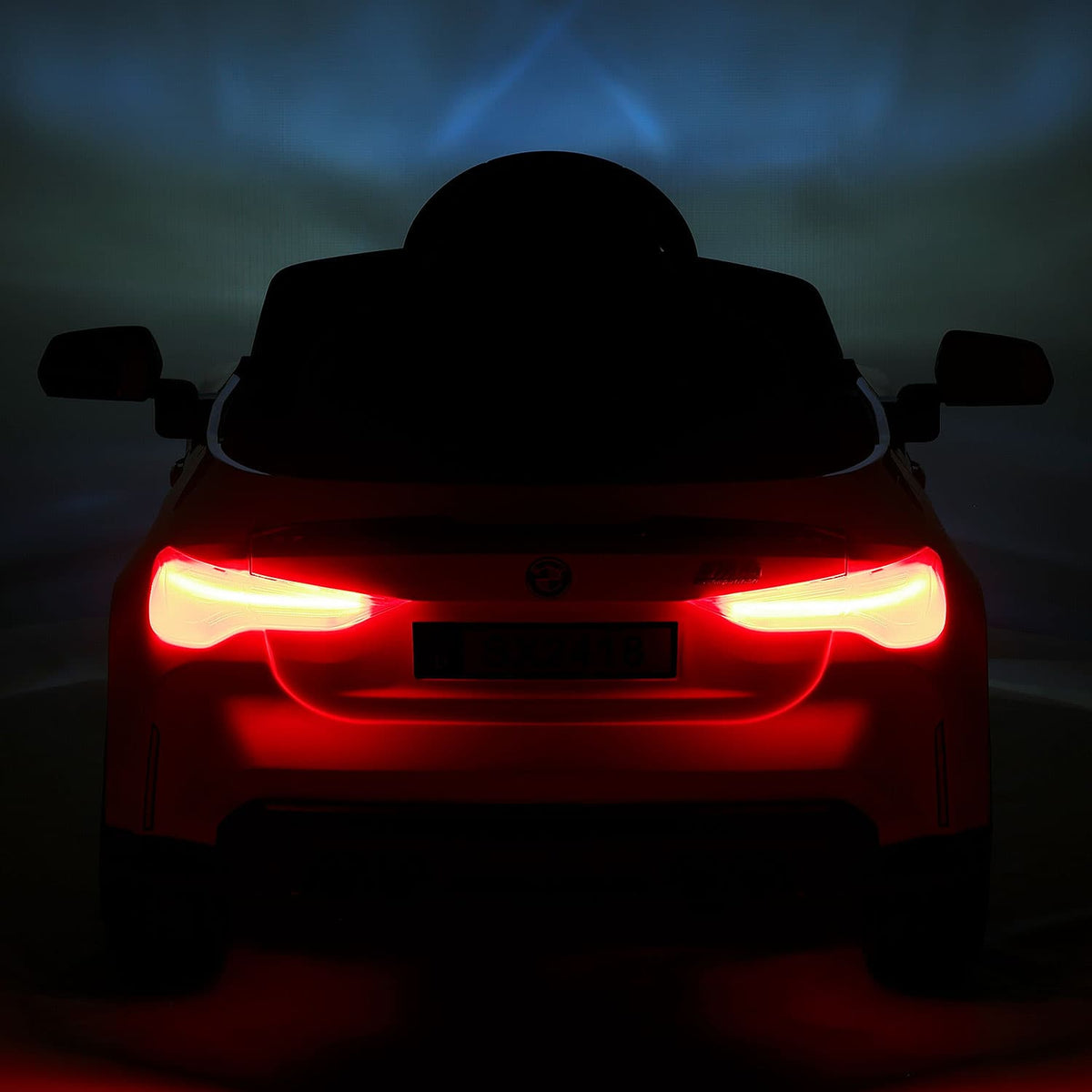 Lit LED Tail Lights on the BMW M4 12V Kids Electric Car, Rear View at Night