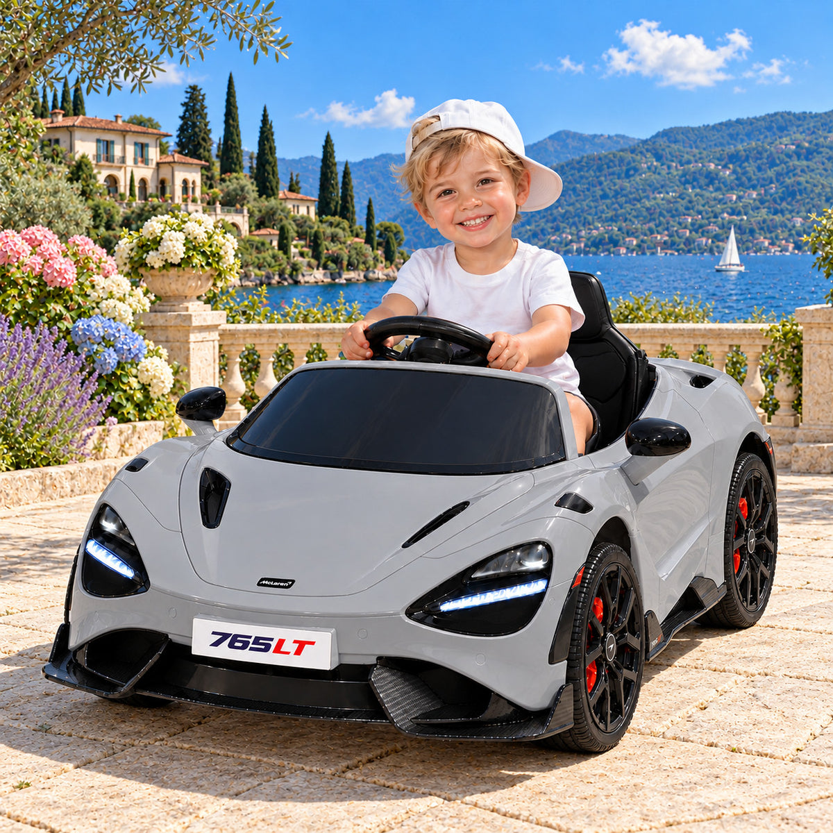 Gray McLaren 765LT 12V Kids Ride-On Car with Parental Remote, Boy Driving on a Lakeside Villa Terrace