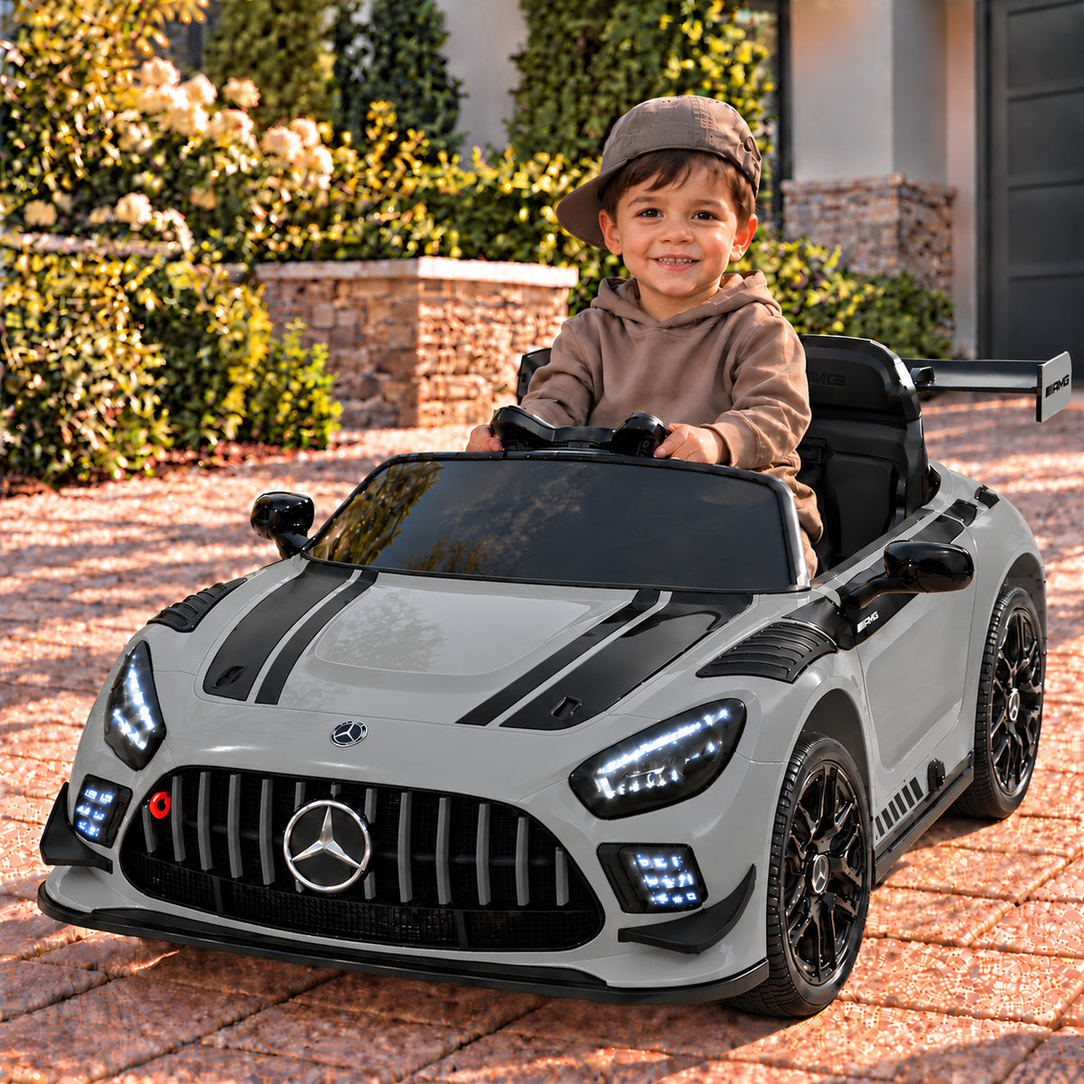 Gray Mercedes AMG GT3 EVO 12V Kids Ride-On Car with Parental Remote, Boy Driving on a Driveway