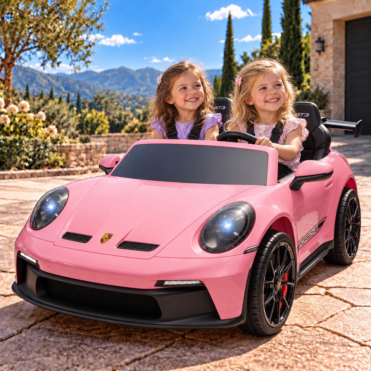 Pink Porsche 911 GT3 24V Kids 2 Seater Ride-On Car, Two Girls Driving on a Villa Driveway