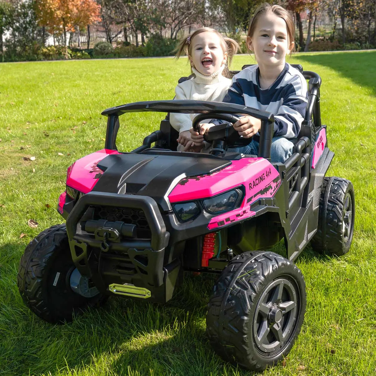 Pink Trail Rider 24V 4WD kids electric ride-on UTV, front view with LED headlights, roof light bar, and dual seats