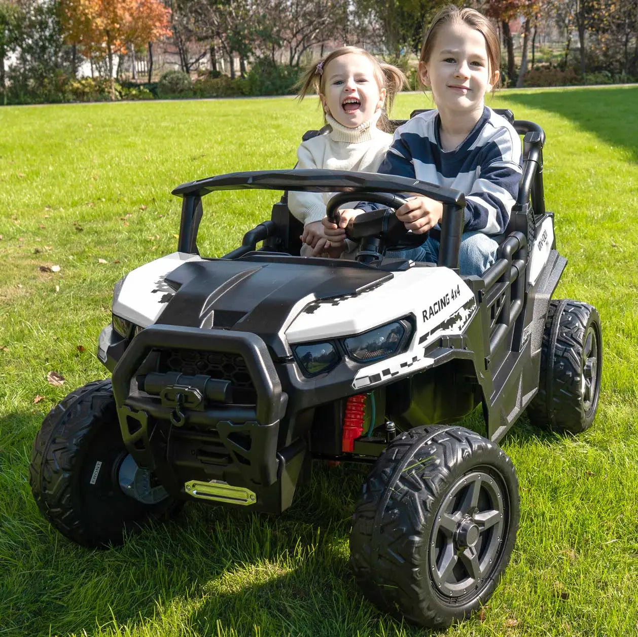 White Trail Rider 24V 4WD kids electric ride-on UTV, front view with LED headlights, roof light bar, and dual seats