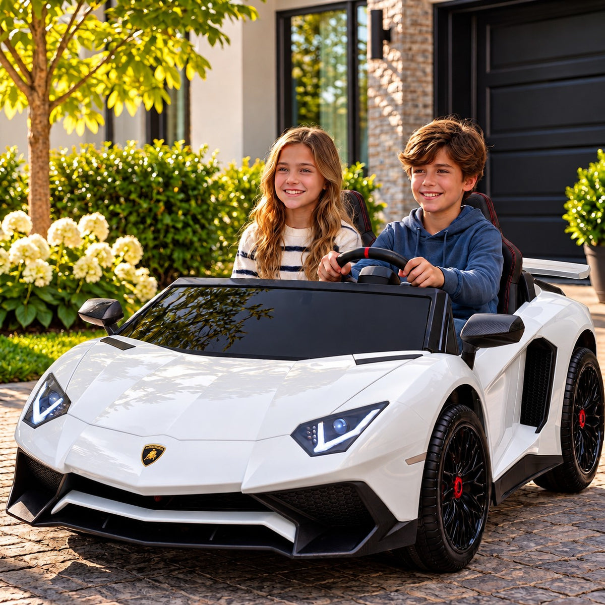 White Lamborghini Aventador XXL 24V Two Seat Ride-On Car for Big Kids Lifestyle, Boy and Girl Driving in Front of the Garage