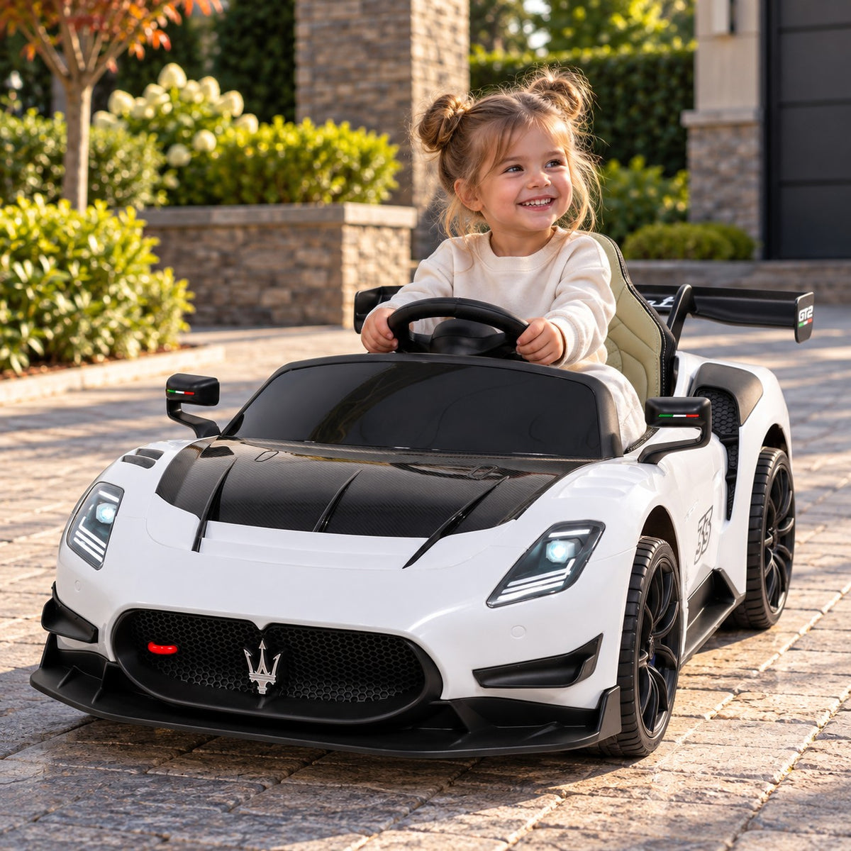 White Maserati GT2 24V Kids Ride-On Car, Girl Driving on a Villa Driveway