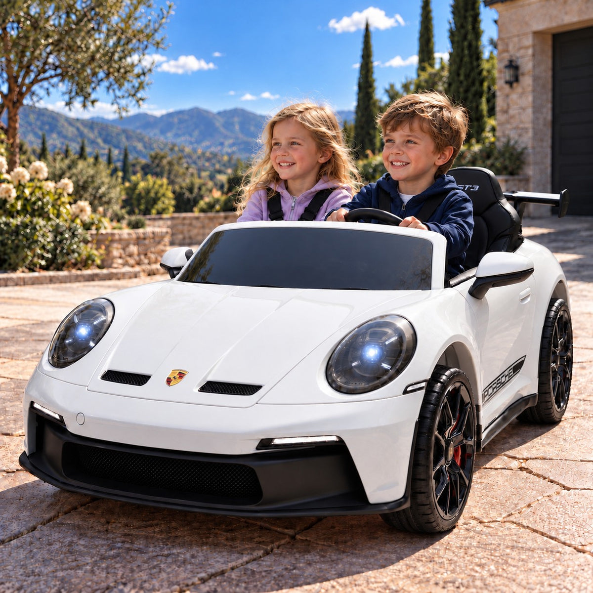 White Porsche 911 GT3 24V Kids 2 Seater Ride-On Car, Boy and Girl Driving on a Villa Driveway
